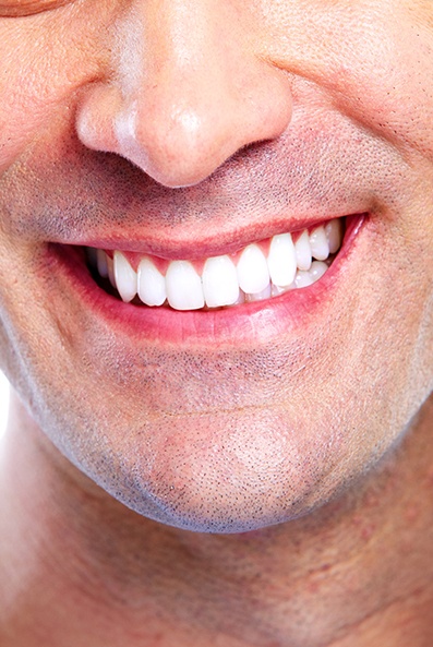 Close up of smiling man with straight white teeth