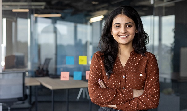 a businesswoman smiling with her arms crossed