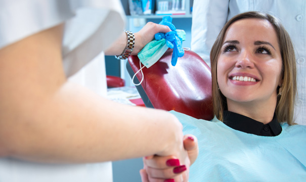 A woman discussing Cigna Dental Insurance coverage at the dentist