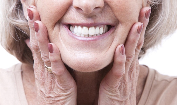Closeup of woman smiling with dentures in Boston