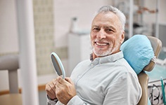 man smiling about the cost of dentures in Boston
