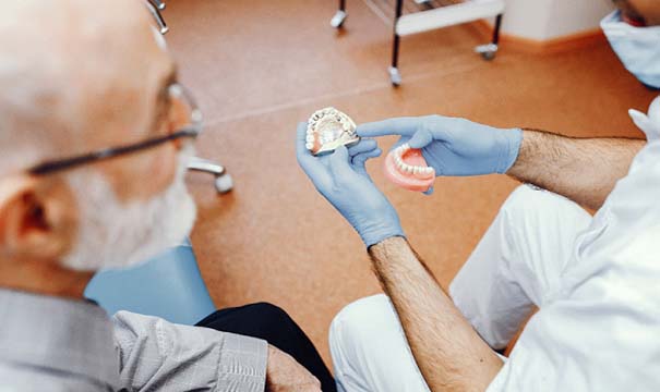 Patient learning more about dentures in Boston