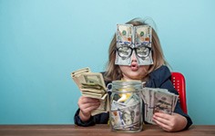 Child having fun with a jar of money