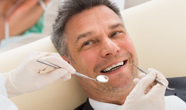 Man smiling after tooth extractions