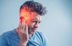 Man with toothache holding jaw in pain