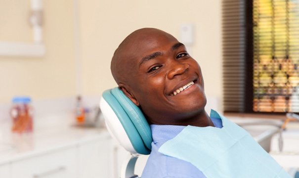 happy patient after treatment for his dental emergency in Boston