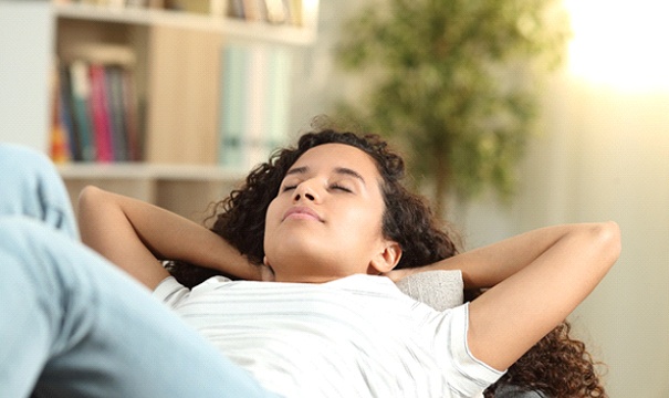 Woman resting after tooth extraction in Boston.