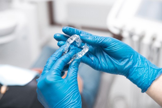 Dentist holding ClearCorrect aligners