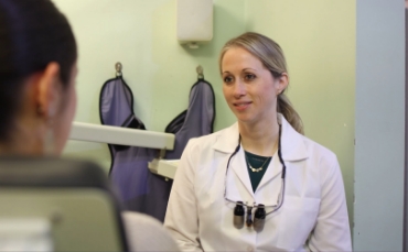 Dental patient looking at her smile in a mirror