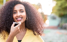 a woman holding Invisalign aligners