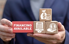 a person holding finance-related building blocks