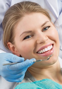 patient smiling while visiting the dentist  