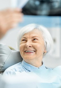 patient smiling while talking to dentist 