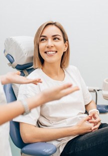 patient smiling while talking to dentist