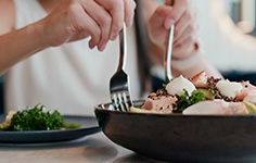 A woman enjoying a salad at a restaurant