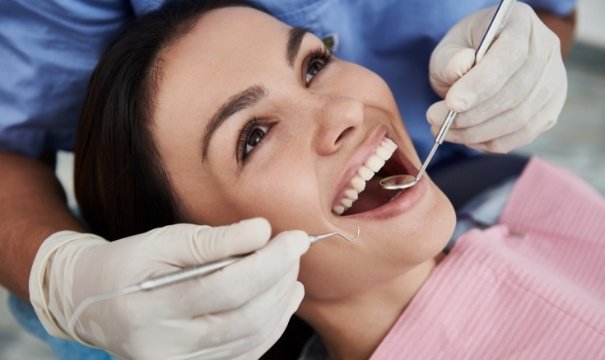 Patient receiving preventive dentistry checkup and teeth cleaning