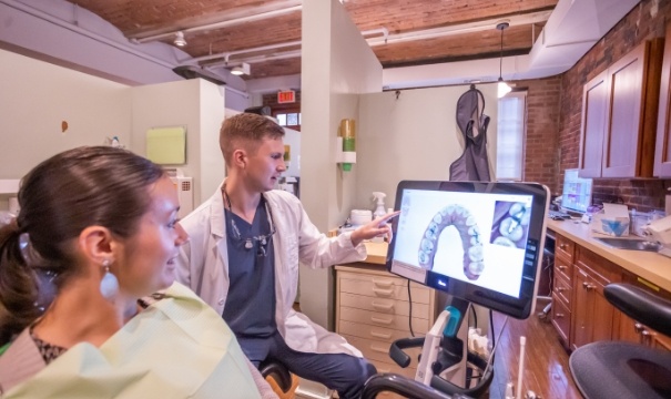 Dentist using intraoral camera to capture smile photos