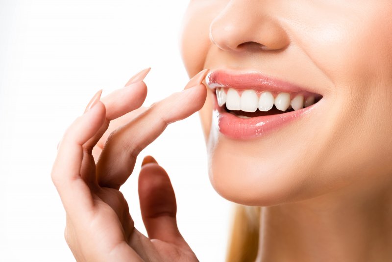 closeup of woman smiling after getting veneers in Boston