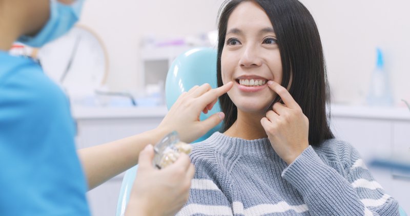 A woman talking to her dentist about dental implants