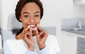 Woman inserting a clear aligner